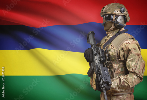 Soldier in helmet holding machine gun with flag on background series - Mauritius