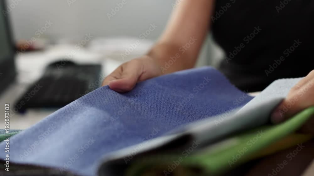 Female fashion designer selecting fabrics