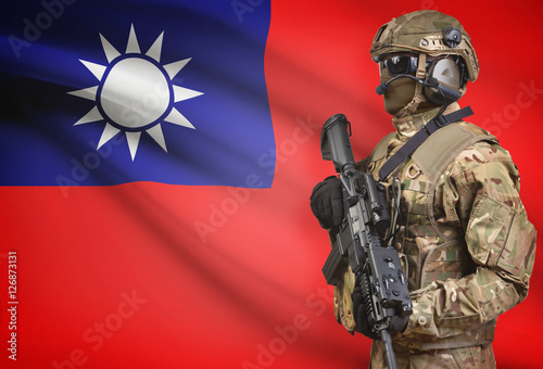 Soldier in helmet holding machine gun with flag on background series - Taiwan