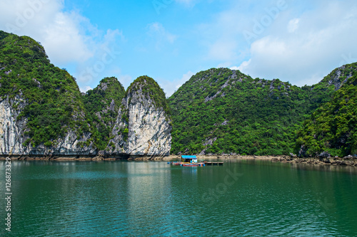 Floating house and rock islands in Halong Bay, Vietnam, Southeast Asia. UNESCO World Heritage Site. Scenic landscape mountain sea at Ha Long Bay. Most popular landmark, tourist destination of Vietnam. © 12ee12