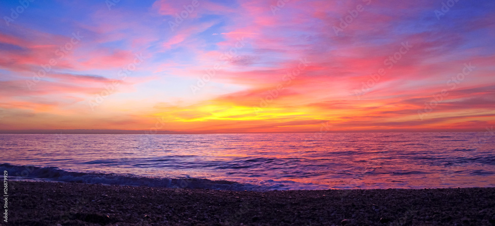 Panoramic sunrise over the clouds in the Mediterranean sea