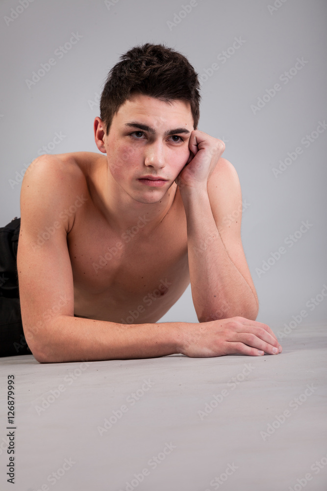 Healthy muscular young man on grey background Healthy muscular young man on grey background