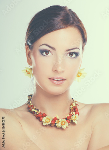 Portrait of young beautiful brunette woman in beads