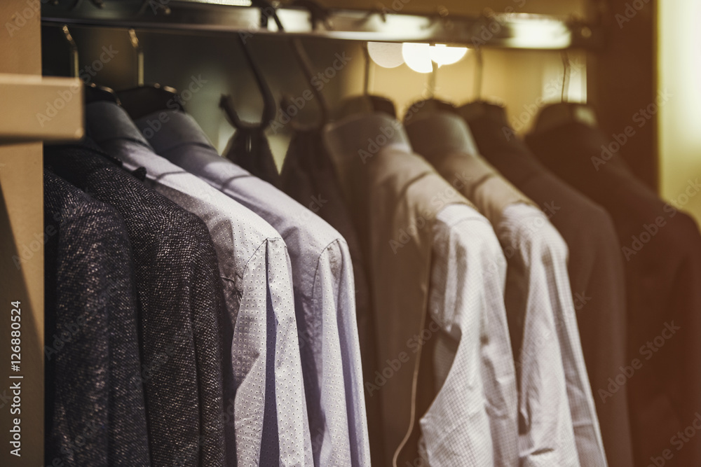 Men clothing on hangers in a fancy shoip Men clothing on hangers in a fancy shoip