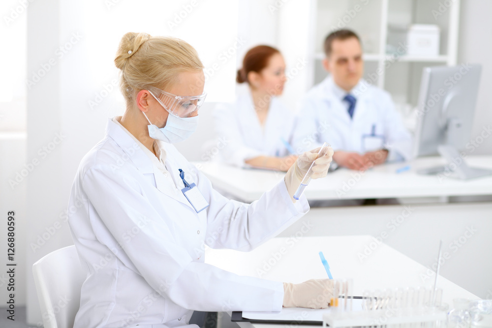 Scientific research team with clear solution in laboratory Scientific research team with clear solution in laboratory