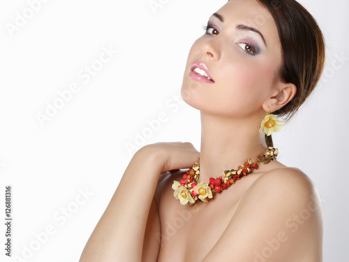 Portrait of young beautiful brunette woman in beads