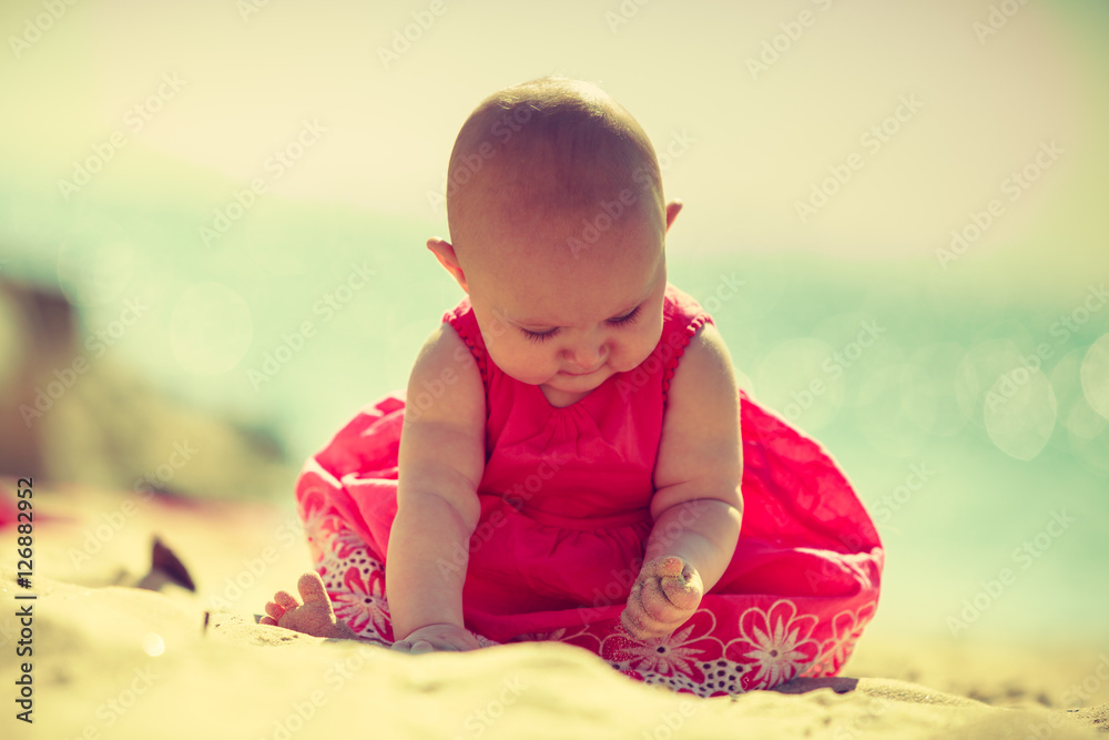 Little baby sitting and playing on beach Little baby sitting and playing on beach