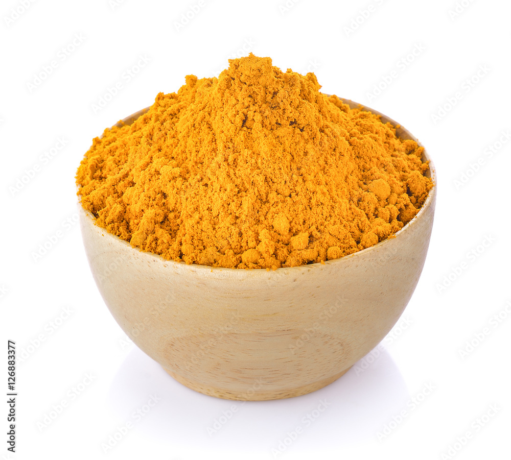 turmeric in wood bowl on white background turmeric in wood bowl on white background