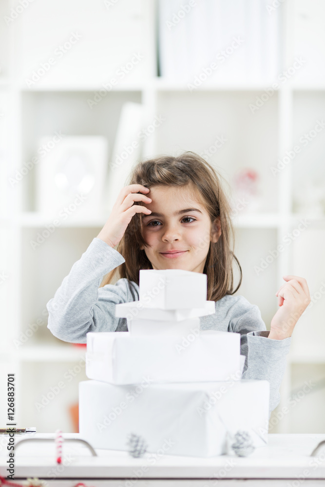 Little girl is standing next to her Christmas presents. Little girl is standing next to her Christmas presents.