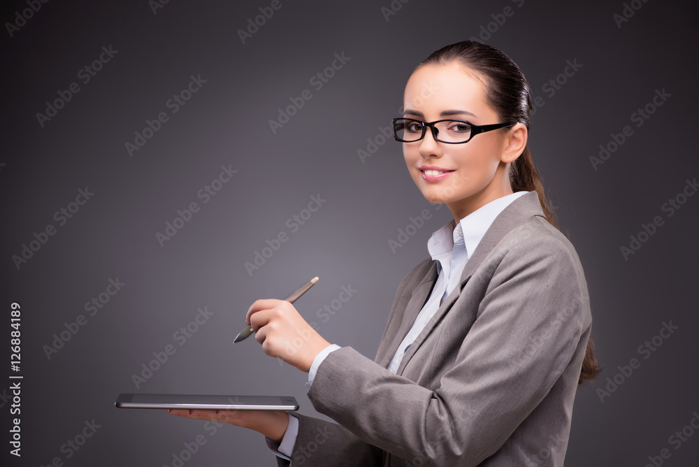 Businesswoman working on tablet computer in business concept Businesswoman working on tablet computer in business concept