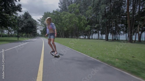 Wallpaper Mural REAR POV WS Blonde young woman skateboarding down road Torontodigital.ca