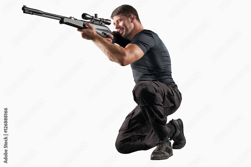Soldier with sniper rifle aiming isolated on white Soldier with sniper rifle aiming isolated on white