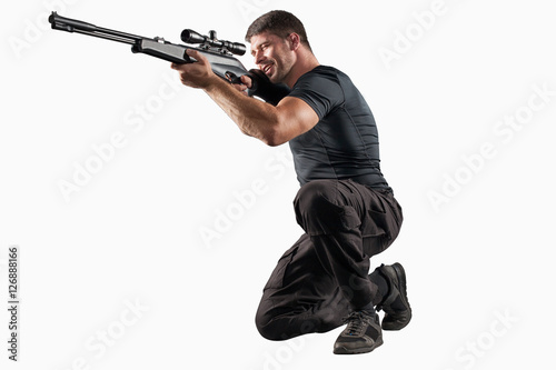 Photo Soldier with sniper rifle aiming isolated on white