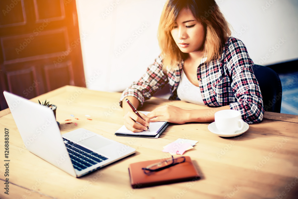 Business Woman Writing with pen in notepad on workplace. Business Woman Writing with pen in notepad on workplace.