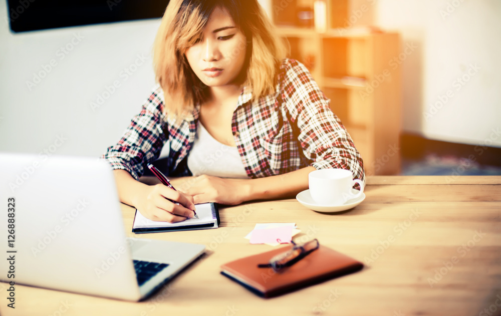 Business Woman Writing with pen in notepad on workplace. Business Woman Writing with pen in notepad on workplace.