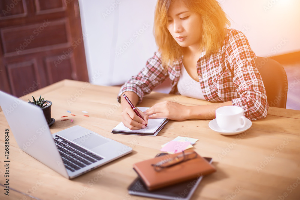 Business Woman Writing with pen in notepad on workplace. Business Woman Writing with pen in notepad on workplace.