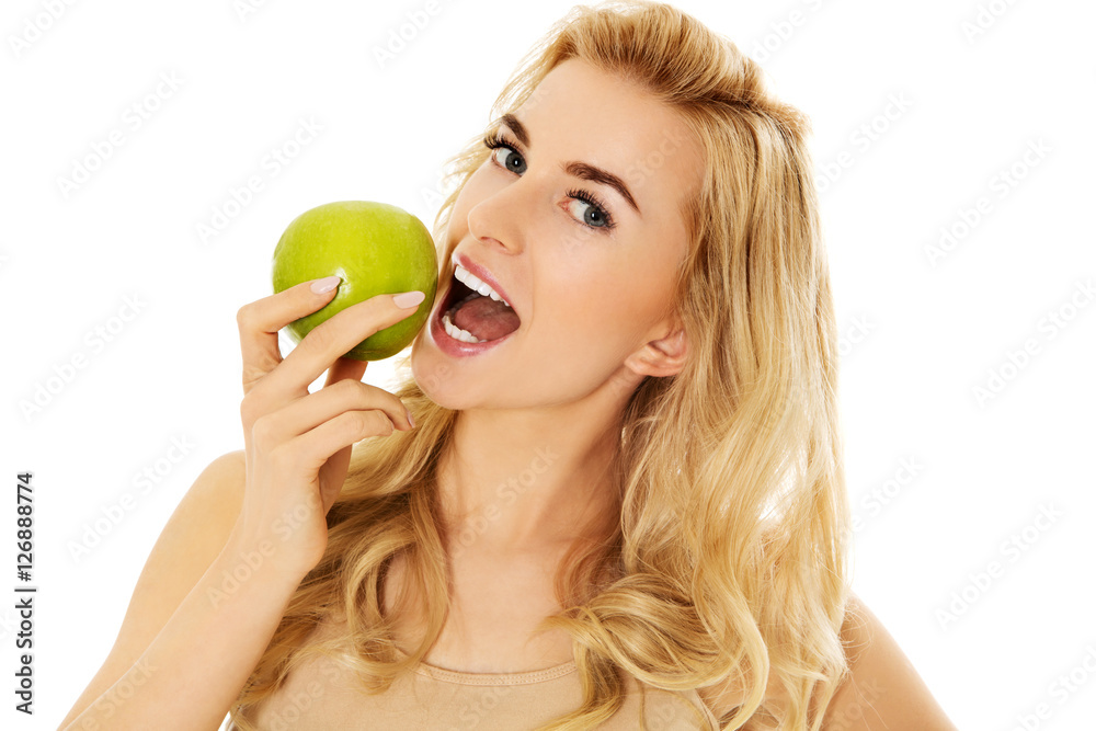 Young happy woman eating fresh green apple Young happy woman eating fresh green apple