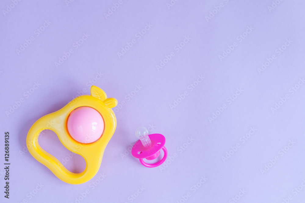 Fototapeta premium baby rattle on purple background