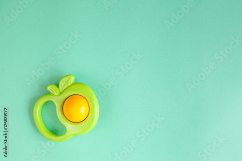 baby rattle on green background photo