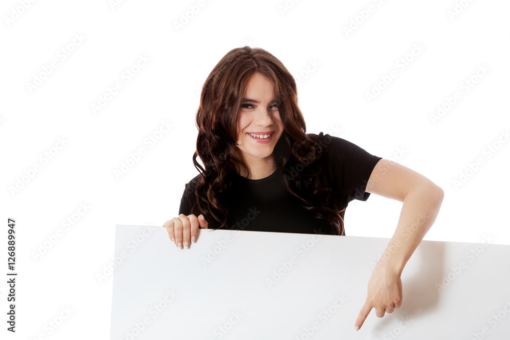 Smiling young business woman holding blank signboard Smiling young business woman holding blank signboard
