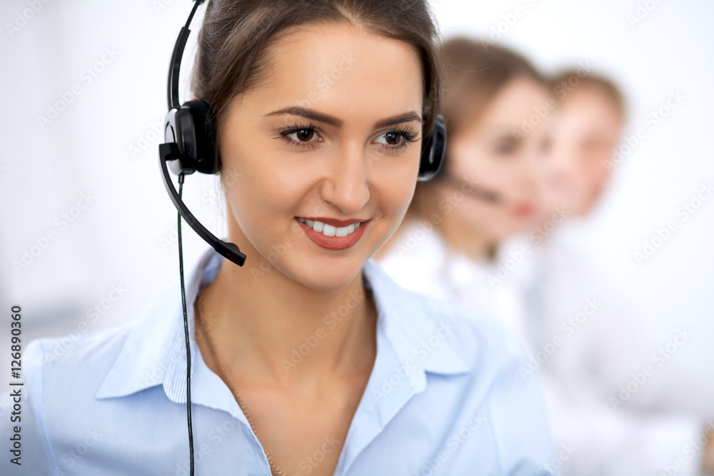 Call center. Focus on beautiful woman in headset Call center. Focus on beautiful woman in headset