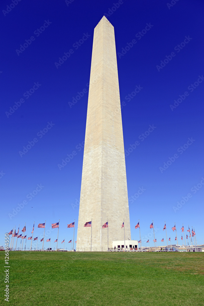 Washington Monument with waving American Flag in foreground, Washington DC, USA