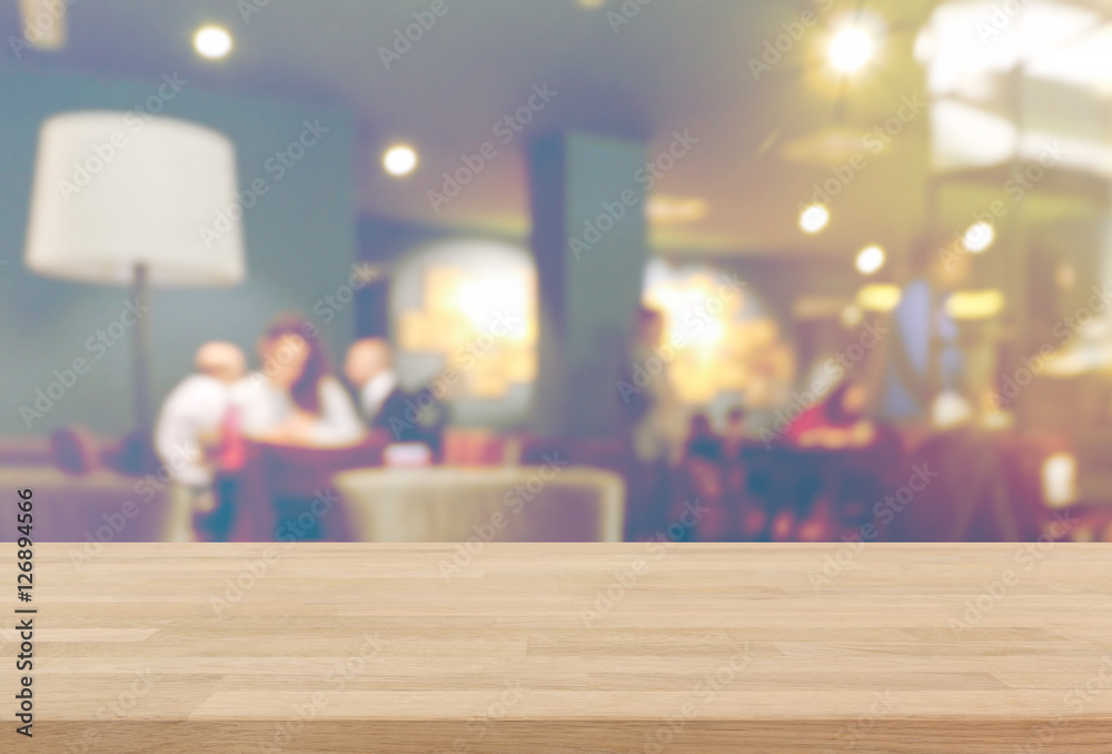 Wood table top and blurred restaurant interior background with vintage filter - can used for display or montage your products. Wood table top and blurred restaurant interior background with vintage filter - can used for display or montage your products.