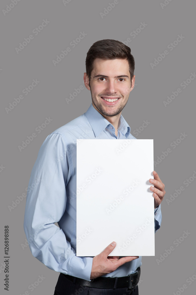 Portrait of a Man with a sign on a gray background Portrait of a Man with a sign on a gray background