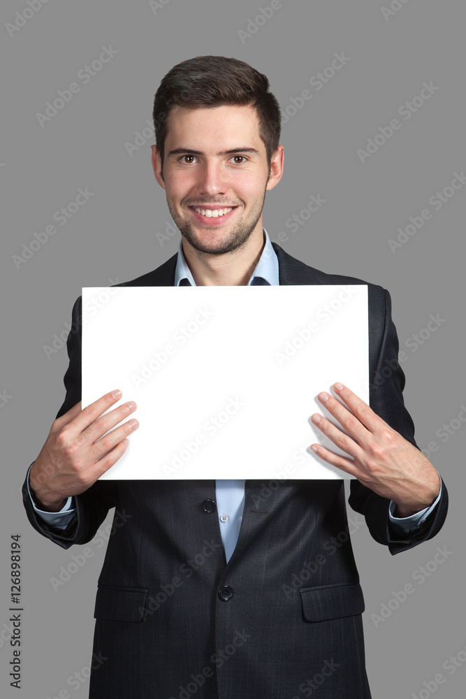 Portrait of a Man with a sign on a gray background Portrait of a Man with a sign on a gray background