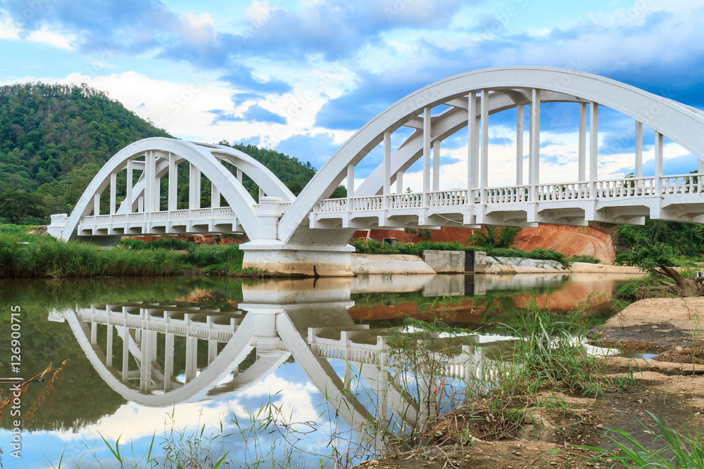 Fototapeta premium White bridge backdrop blue sky at mae tha, Lamphun, Thailand.
