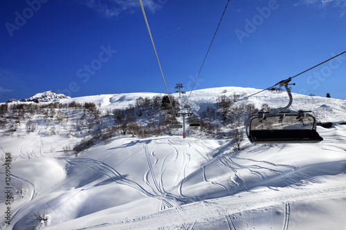 Chair-lift at ski resort in sun winter day