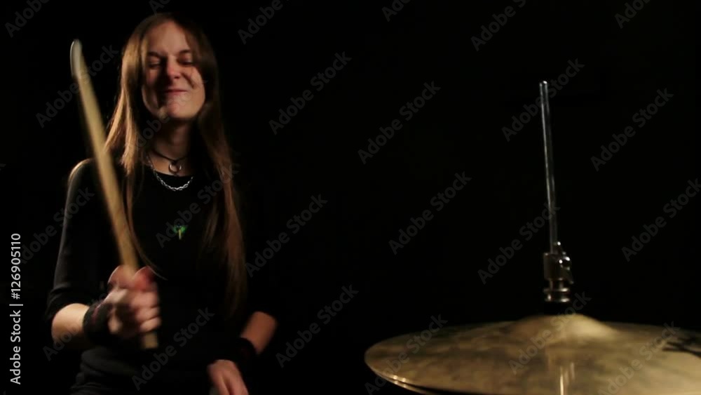 the drummer plays on Hihat in a dark room.