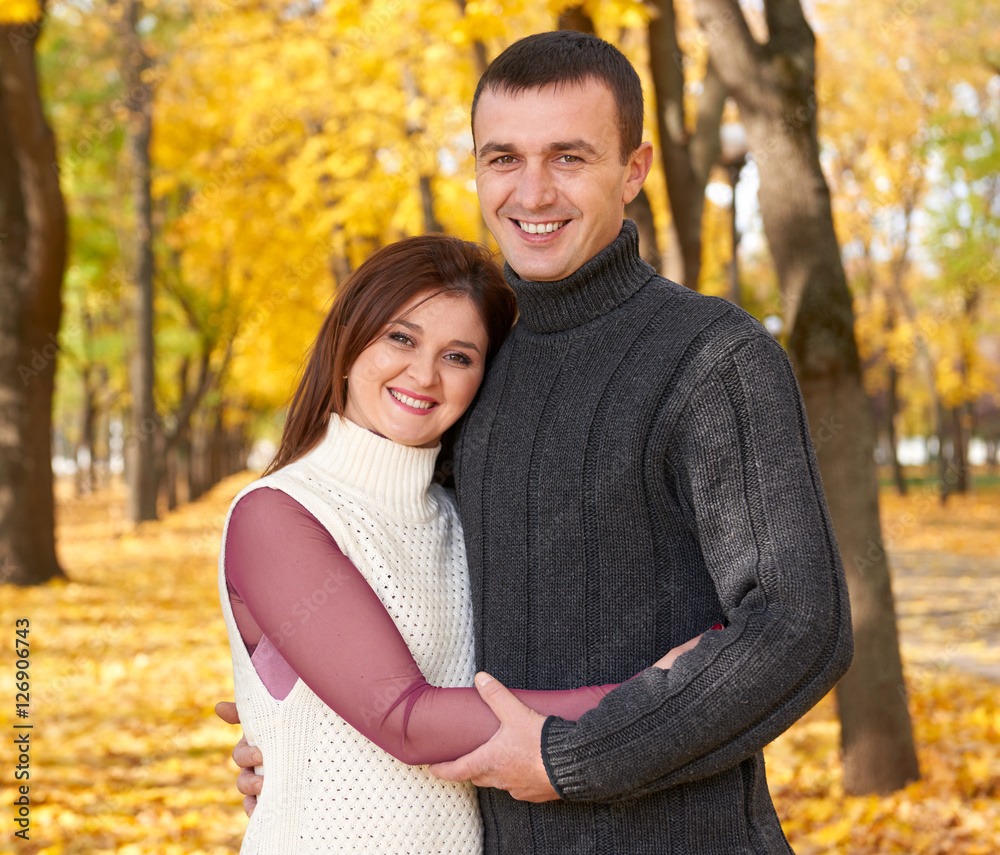 happy adult couple embrace in autumn city park, trees with yellow leaves, bright sun and happy emotions, tenderness and feelings happy adult couple embrace in autumn city park, trees with yellow leaves, bright sun and happy emotions, tenderness and feelings