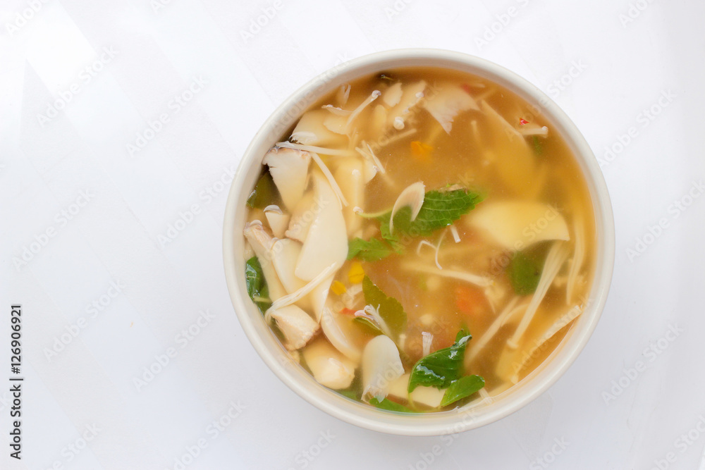 Hot and Spicy Soup with mushroom, mix vegetable and Thai herbs in white bowl on white background ,Vegetarian Food, Healthy food Hot and Spicy Soup with mushroom, mix vegetable and Thai herbs in white bowl on white background ,Vegetarian Food, Healthy food