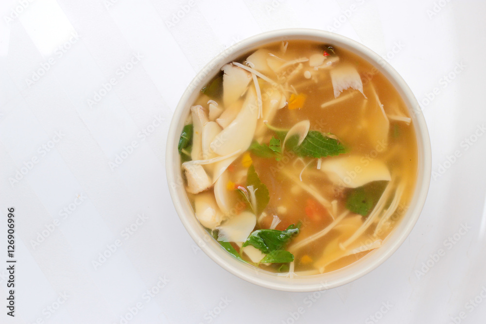 Hot and Spicy Soup with mushroom, mix vegetable and Thai herbs in white bowl on white background ,Vegetarian Food, Healthy food Hot and Spicy Soup with mushroom, mix vegetable and Thai herbs in white bowl on white background ,Vegetarian Food, Healthy food