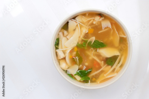 Hot and Spicy Soup with mushroom, mix vegetable and Thai herbs in white bowl on white background ,Vegetarian Food, Healthy food