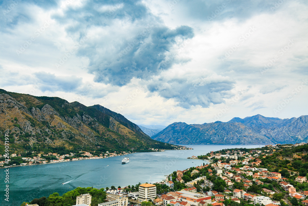 View of cityscape, old town, sea, coast and cloudy sky from Lovcen mountain in Kotor, Montenegro. Panoramic views of Bay of Kotor.
