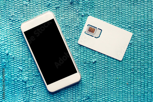 Smartphone with blank screen and mobile phone SIM card photo