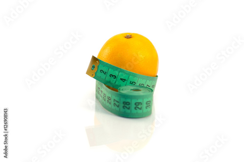 Orange and measuring tape on a white background.