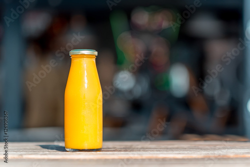 Raw orange juice in glass bottle