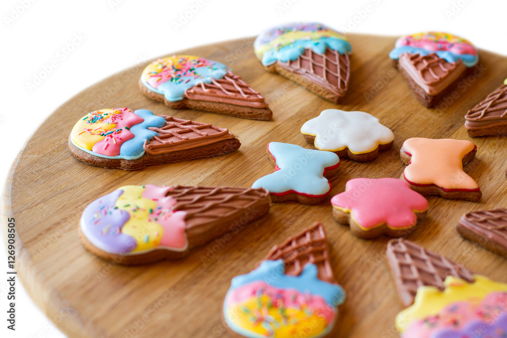Cookies on a wooden board. Colorful glazed biscuits. Holiday desserts for kids. Pastry with sugar frosting. Cookies on a wooden board. Colorful glazed biscuits. Holiday desserts for kids. Pastry with sugar frosting.