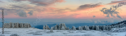 Amazing pink purple winter sunset in the mountains - beautiful frozen landscape - colorful panorama