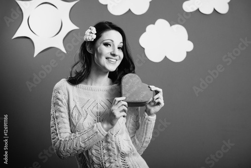 Elegant beautiful girl in with red heart shaped present box portrait standing at blue screen background