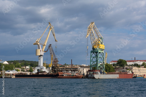 Lifting cargo cranes at the shipyard in Bay of Black Sea.