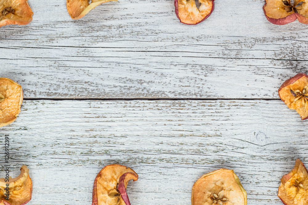 Dried apple slices on wooden table Dried apple slices on wooden table