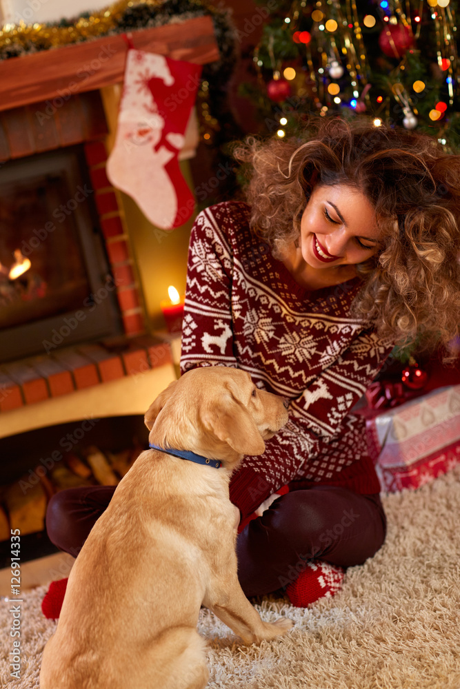 Curly girl with nice dog in Christmas evening. Curly girl with nice dog in Christmas evening.