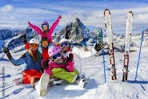 Skiing, winter, snow, sun and fun - family enjoying winter vacat