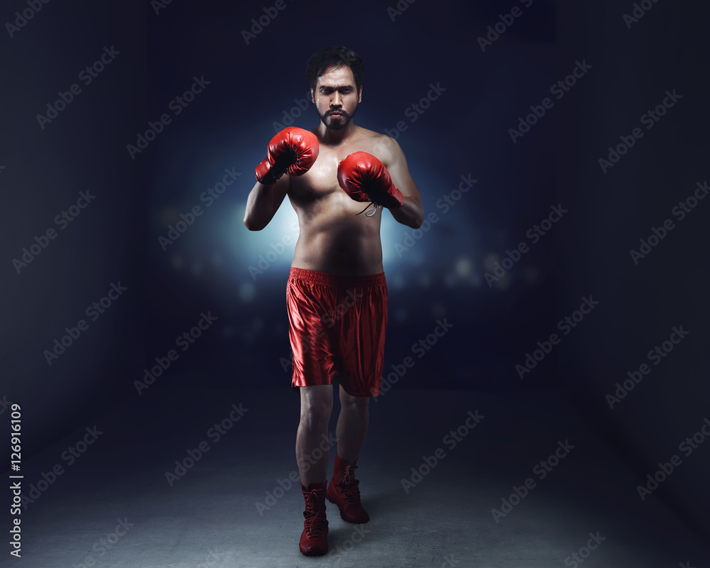 Portrait of asian male boxer with red gloves