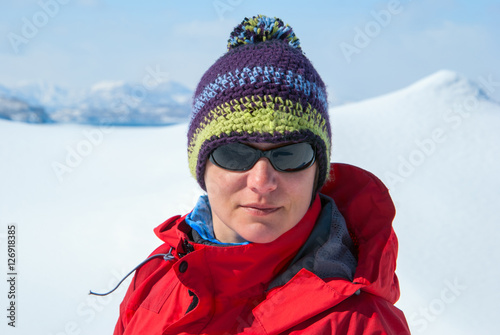 Portrait of hiker woman on the background of winter mountains