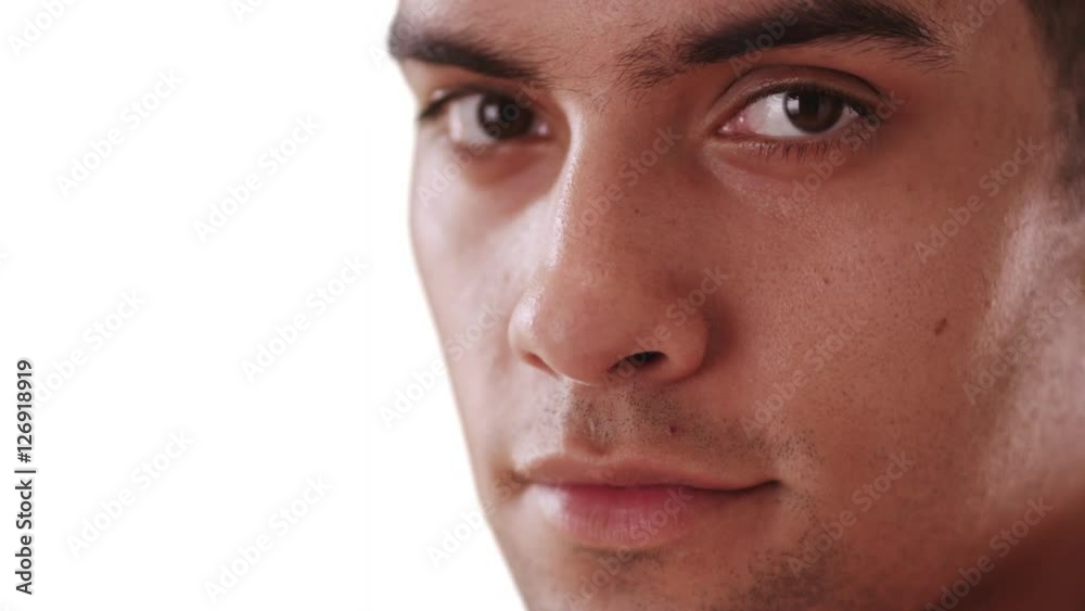 Close up of serious millennial Hispanic man on white background with copy space. Serious Latino in his 20s looking at camera with copyspace Close up of serious millennial Hispanic man on white background with copy space. Serious Latino in his 20s looking at camera with copyspace